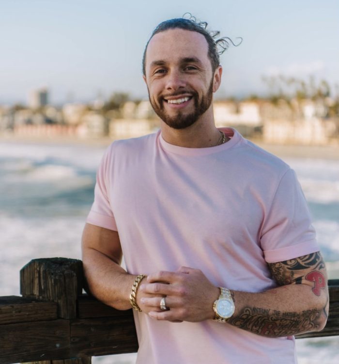 rudy-pinkshirt-on-beach-smiling